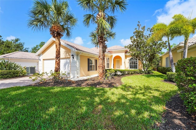7716 Uliva Way, Sarasota, FL 34238 - view of front of property with stucco siding, a garage, a front lawn, driveway, and a tile roof