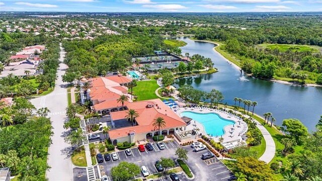 7716 Uliva Way, Sarasota, FL 34238 - bird's eye view of a nearby body of water, a pool, and a forest