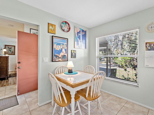 4869 Village Gardens Dr Unit 189, Sarasota, FL 34234 - dining room with healthy amount of natural light and light tile patterned flooring