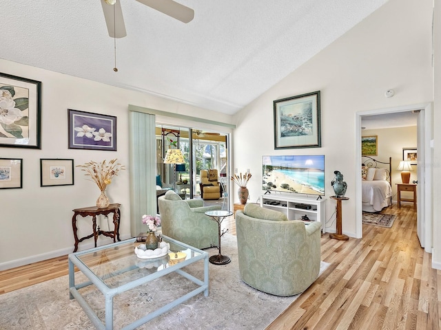 4869 Village Gardens Dr Unit 189, Sarasota, FL 34234 - living area with light wood finished floors, vaulted ceiling, a ceiling fan, and a textured ceiling
