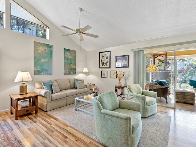 4869 Village Gardens Dr Unit 189, Sarasota, FL 34234 - living room featuring ceiling fan, plenty of natural light, a textured ceiling, light wood-style flooring, and high vaulted ceiling