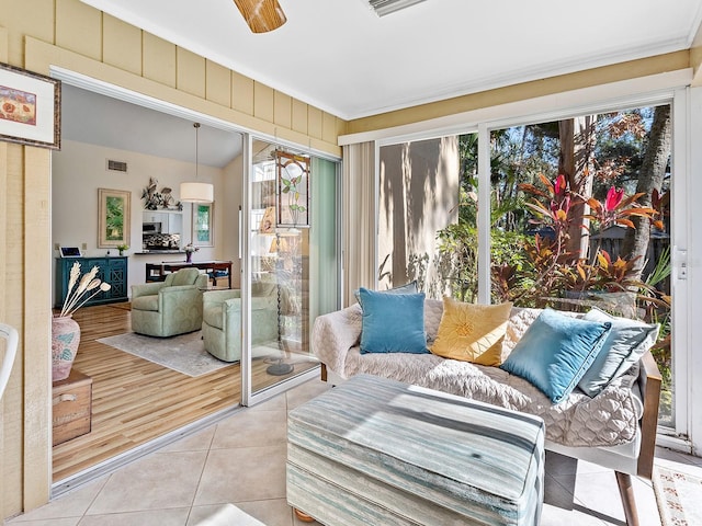 4869 Village Gardens Dr Unit 189, Sarasota, FL 34234 - sunroom / solarium featuring healthy amount of natural light, tile patterned floors, and crown molding