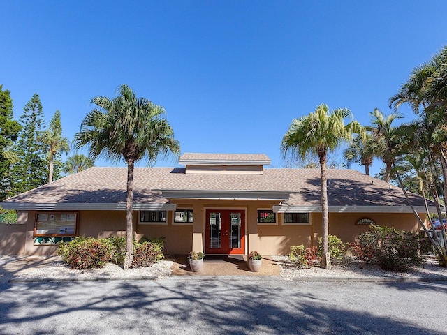 4869 Village Gardens Dr Unit 189, Sarasota, FL 34234 - view of front of home with french doors and roof with shingles