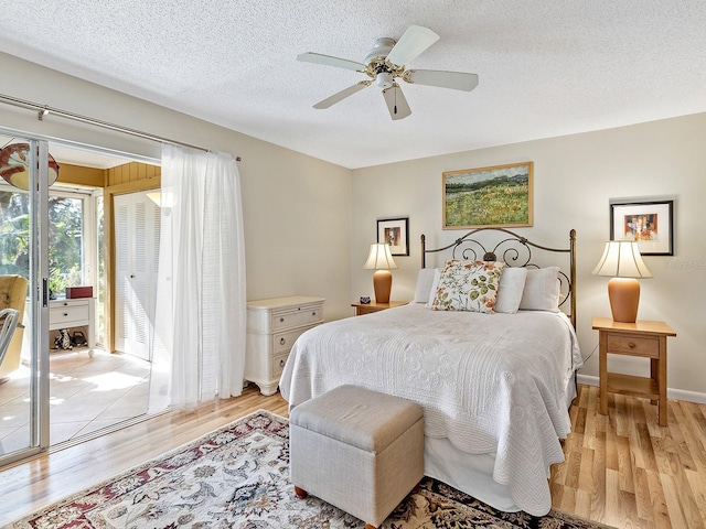 4869 Village Gardens Dr Unit 189, Sarasota, FL 34234 - bedroom with access to outside, light wood finished floors, a textured ceiling, and a ceiling fan