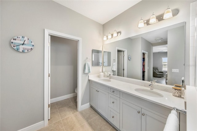 4406 Rustling Pines Ter, Parrish, FL 34219 - bathroom with double vanity, toilet, baseboards, and tile patterned floors