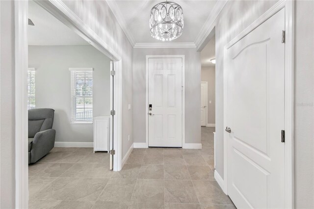4406 Rustling Pines Ter, Parrish, FL 34219 - foyer entrance featuring a chandelier, ornamental molding, and light tile patterned floors