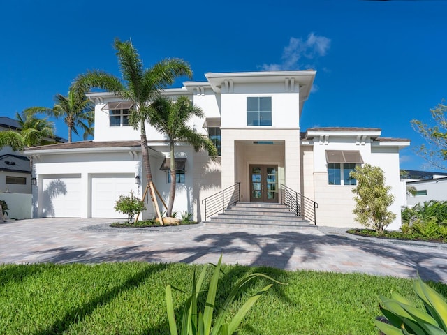 430 Pheasant Way, Sarasota, FL 34236 - view of front of home featuring french doors, driveway, an attached garage, and stucco siding