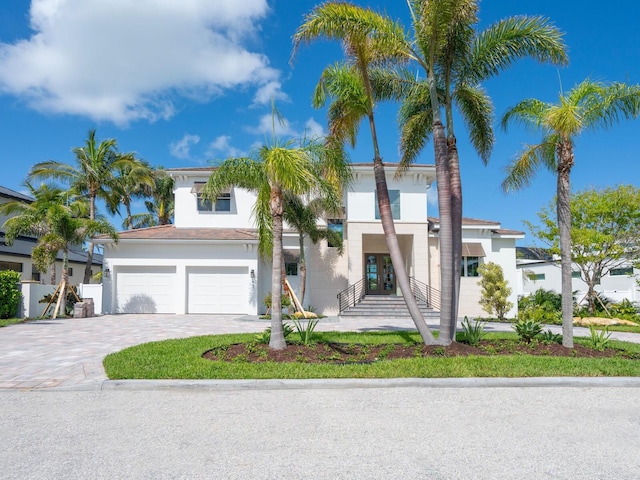 430 Pheasant Way, Sarasota, FL 34236 - view of front facade featuring french doors, decorative driveway, stucco siding, and a garage