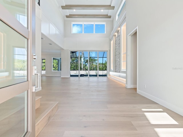 430 Pheasant Way, Sarasota, FL 34236 - hallway with a towering ceiling, beamed ceiling, and light wood finished floors