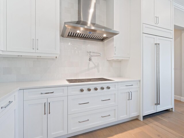 430 Pheasant Way, Sarasota, FL 34236 - kitchen featuring range hood, light wood-type flooring, and white cabinets