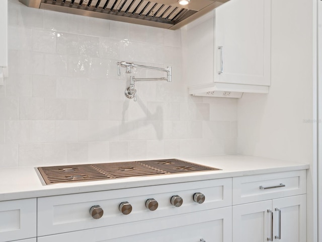 430 Pheasant Way, Sarasota, FL 34236 - kitchen with custom range hood, backsplash, light countertops, and white cabinets