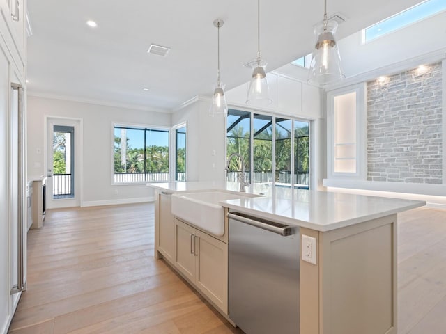430 Pheasant Way, Sarasota, FL 34236 - kitchen featuring stainless steel dishwasher, open floor plan, light countertops, light wood-type flooring, and an island with sink