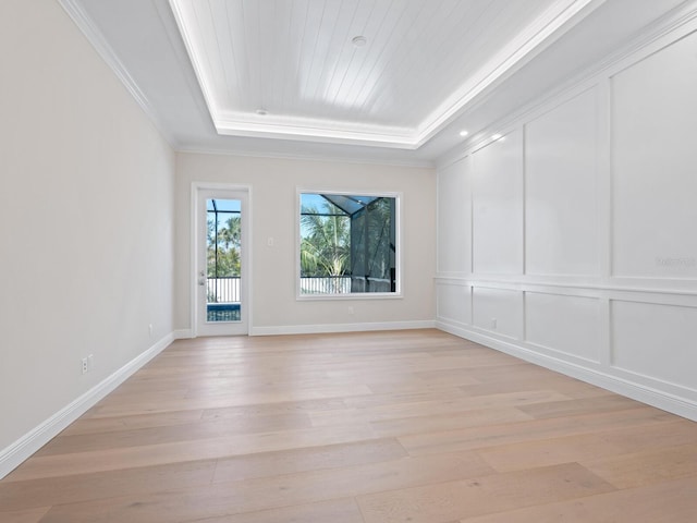 430 Pheasant Way, Sarasota, FL 34236 - spare room with a tray ceiling, light wood-style flooring, and crown molding