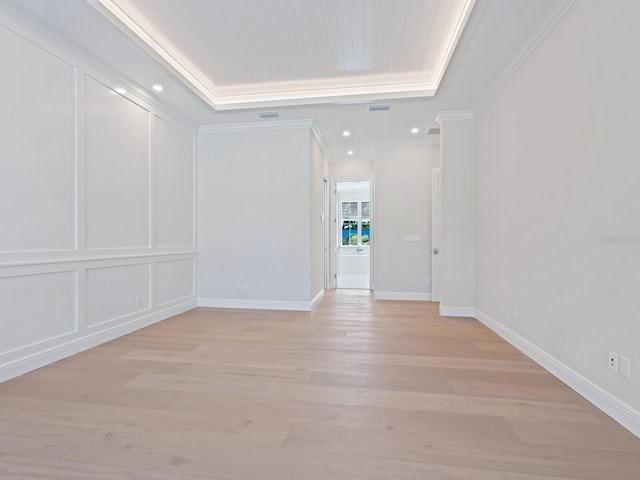 430 Pheasant Way, Sarasota, FL 34236 - spare room with light wood finished floors, ornamental molding, recessed lighting, and a tray ceiling