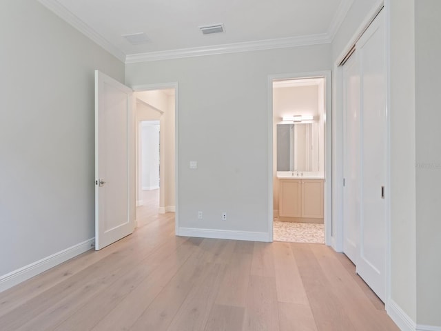 430 Pheasant Way, Sarasota, FL 34236 - unfurnished bedroom featuring light wood-style floors, ornamental molding, a closet, and ensuite bathroom