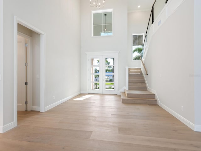 430 Pheasant Way, Sarasota, FL 34236 - entrance foyer with stairway, light wood-style flooring, a high ceiling, and a chandelier