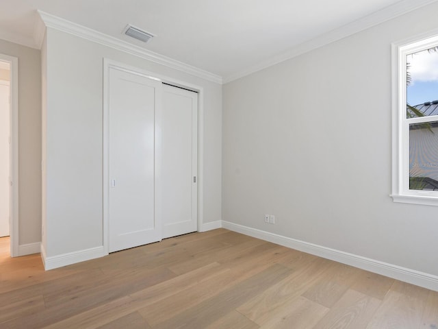 430 Pheasant Way, Sarasota, FL 34236 - unfurnished bedroom with light wood-style flooring, ornamental molding, and a closet