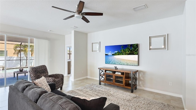 7379 47th Avenue Cir E, Bradenton, FL 34203 - living area with a ceiling fan, tile patterned flooring, and baseboards