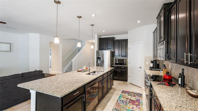 7379 47th Avenue Cir E, Bradenton, FL 34203 - kitchen featuring stainless steel appliances, a sink, tasteful backsplash, open floor plan, and light stone countertops
