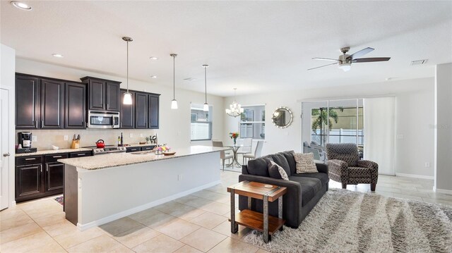 7379 47th Avenue Cir E, Bradenton, FL 34203 - kitchen with stainless steel appliances, ceiling fan, tasteful backsplash, open floor plan, and recessed lighting