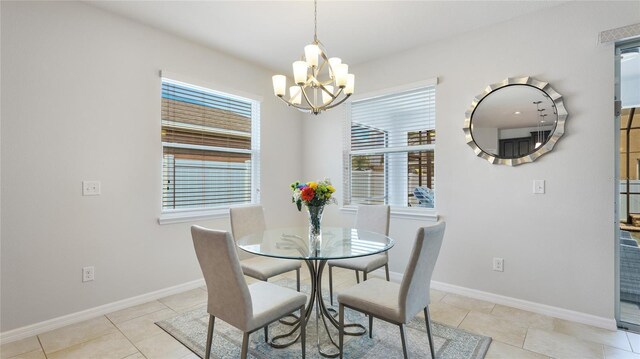 7379 47th Avenue Cir E, Bradenton, FL 34203 - dining space featuring a chandelier, healthy amount of natural light, baseboards, and light tile patterned flooring