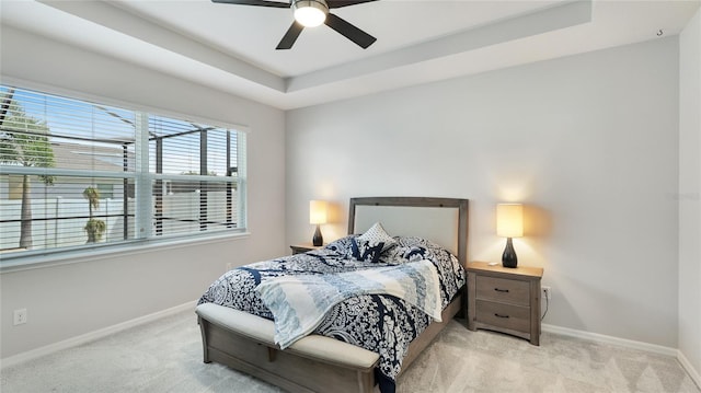 7379 47th Avenue Cir E, Bradenton, FL 34203 - bedroom featuring carpet floors, baseboards, a raised ceiling, and ceiling fan