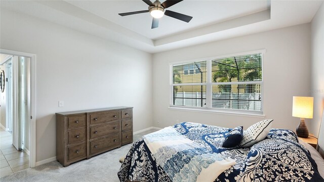7379 47th Avenue Cir E, Bradenton, FL 34203 - bedroom featuring baseboards, a raised ceiling, light carpet, and a ceiling fan