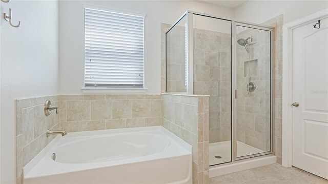 7379 47th Avenue Cir E, Bradenton, FL 34203 - bathroom with a garden tub, a shower stall, and tile patterned floors