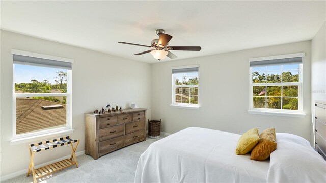 7379 47th Avenue Cir E, Bradenton, FL 34203 - bedroom with light carpet, baseboards, and ceiling fan
