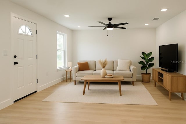 living room with light wood-style flooring, recessed lighting, ceiling fan, and baseboards