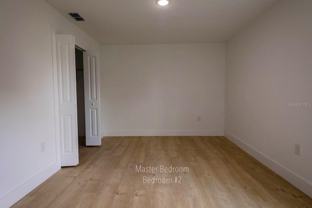 empty room with light wood-type flooring, baseboards, and recessed lighting