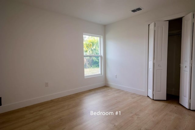 unfurnished bedroom featuring light wood finished floors and baseboards