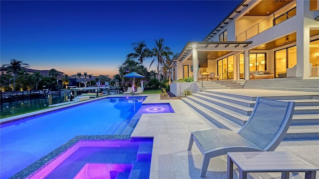 612 Mourning Dove Dr, Sarasota, FL 34236 - pool at dusk featuring a patio and a pool with connected hot tub