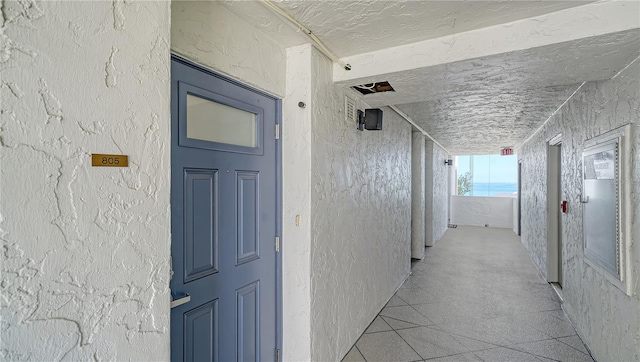 19 Whispering Sands Dr Unit 805, Sarasota, FL 34242 - hall featuring a textured wall and a textured ceiling