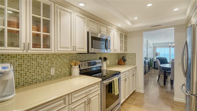 19 Whispering Sands Dr Unit 805, Sarasota, FL 34242 - kitchen with appliances with stainless steel finishes, tasteful backsplash, light countertops, recessed lighting, and baseboards