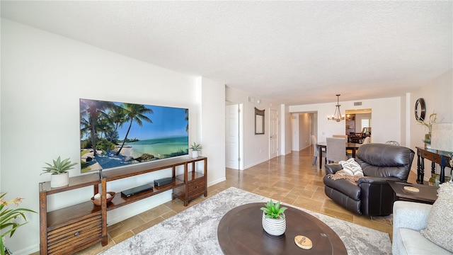19 Whispering Sands Dr Unit 805, Sarasota, FL 34242 - living room featuring a chandelier and a textured ceiling