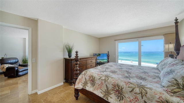 19 Whispering Sands Dr Unit 805, Sarasota, FL 34242 - bedroom with a textured ceiling and baseboards