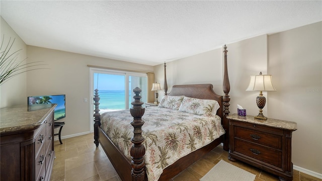 19 Whispering Sands Dr Unit 805, Sarasota, FL 34242 - bedroom featuring baseboards and a textured ceiling