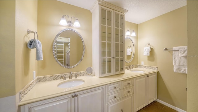 19 Whispering Sands Dr Unit 805, Sarasota, FL 34242 - full bathroom featuring double vanity, tile patterned floors, and baseboards