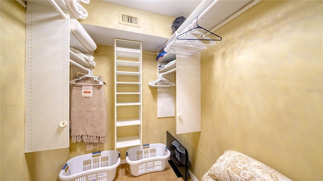 19 Whispering Sands Dr Unit 805, Sarasota, FL 34242 - walk in closet featuring tile patterned flooring