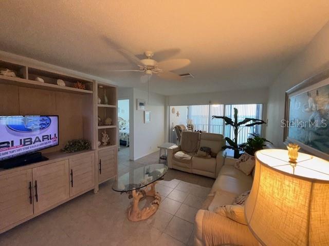 8977 Midnight Pass Rd Unit 521, Sarasota, FL 34242 - living room with a ceiling fan, built in features, and light tile patterned flooring