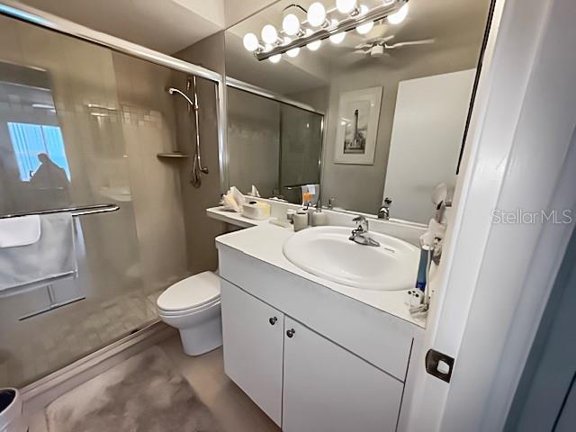 8977 Midnight Pass Rd Unit 521, Sarasota, FL 34242 - bathroom with vanity, toilet, and a stall shower