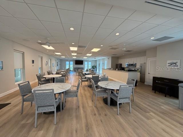 8977 Midnight Pass Rd Unit 521, Sarasota, FL 34242 - dining space with light wood-style floors, baseboards, recessed lighting, a drop ceiling, and ceiling fan