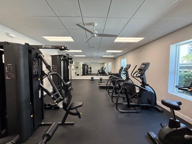 8977 Midnight Pass Rd Unit 521, Sarasota, FL 34242 - gym featuring a paneled ceiling and baseboards