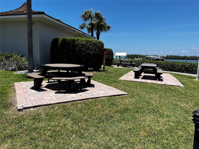8977 Midnight Pass Rd Unit 521, Sarasota, FL 34242 - view of green lawn with a patio area