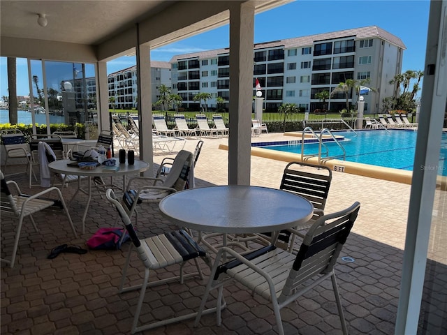 8977 Midnight Pass Rd Unit 521, Sarasota, FL 34242 - view of patio featuring a community pool