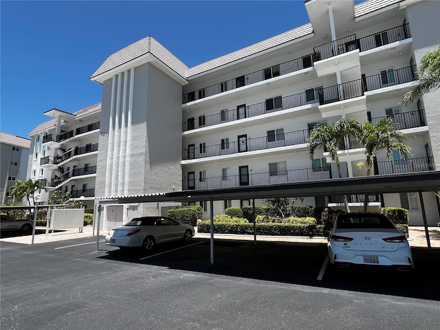 8977 Midnight Pass Rd Unit 521, Sarasota, FL 34242 - view of apartment building / complex featuring covered parking