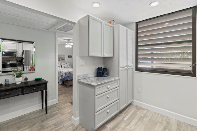 157 Pinehurst Dr Unit 157, Bradenton, FL 34210 - kitchen featuring stainless steel appliances, light wood-style flooring, baseboards, recessed lighting, and ceiling fan