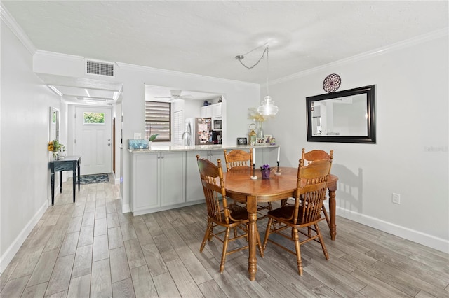 157 Pinehurst Dr Unit 157, Bradenton, FL 34210 - dining space featuring light wood-type flooring, crown molding, baseboards, and a ceiling fan