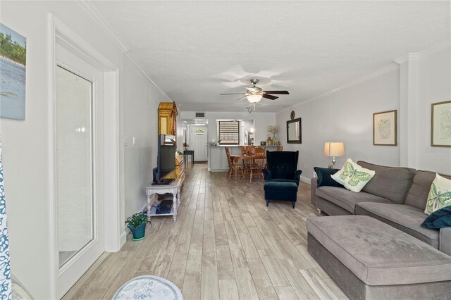 157 Pinehurst Dr Unit 157, Bradenton, FL 34210 - living area featuring a ceiling fan, light wood-type flooring, crown molding, and baseboards